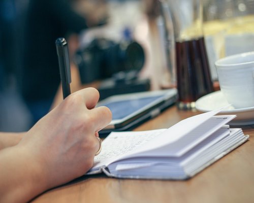 A person stretching hands at office desk